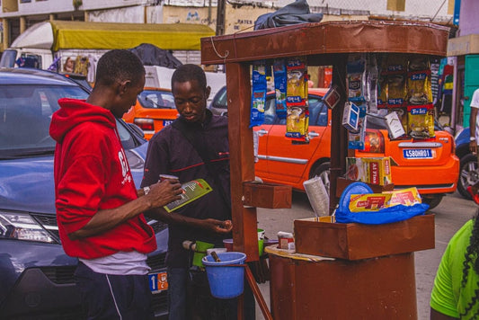 Cross Stitch | Abidjan - Man In Red Polo Shirt Holding Yellow Banana - Cross Stitched