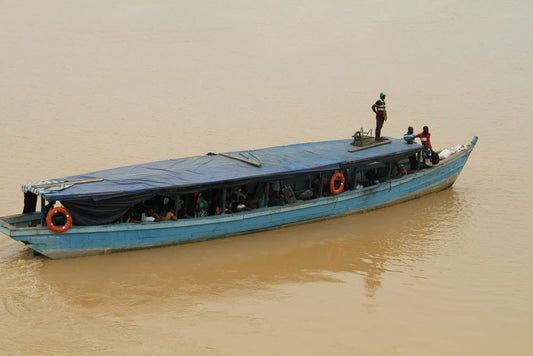 Cross Stitch | Abidjan - People Riding On Blue And White Boat On Water During Daytime - Cross Stitched