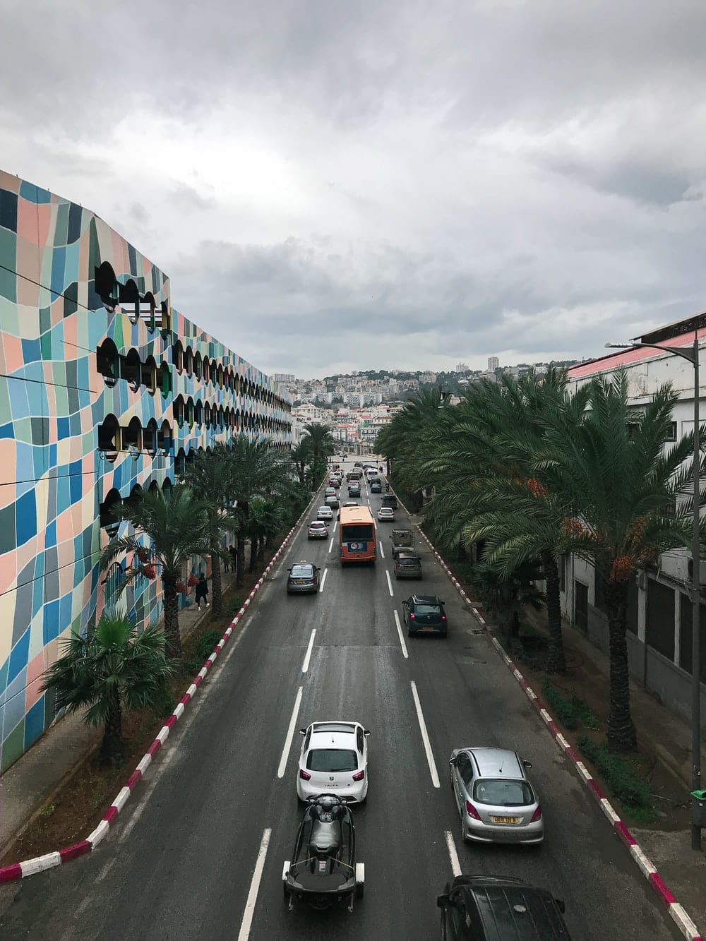 Cross Stitch | Algiers - Cars Parked On Side Of Road Near Building During Daytime - Cross Stitched