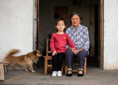 Cross Stitch | Anqing - Girl And Woman Sitting Near Brown Dog - Cross Stitched