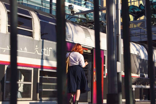 Cross Stitch | Ass - Man In Black Jacket Standing Beside Red And Black Train During Daytime - Cross Stitched