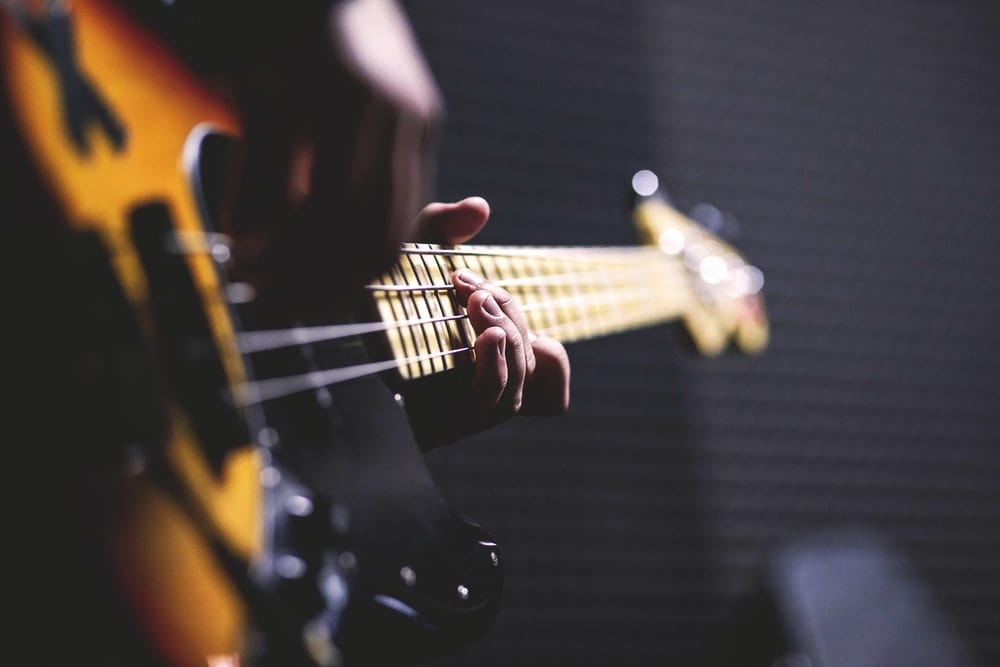 Cross Stitch | Bass - Closeup Photo Of Person Playing Guitar - Cross Stitched