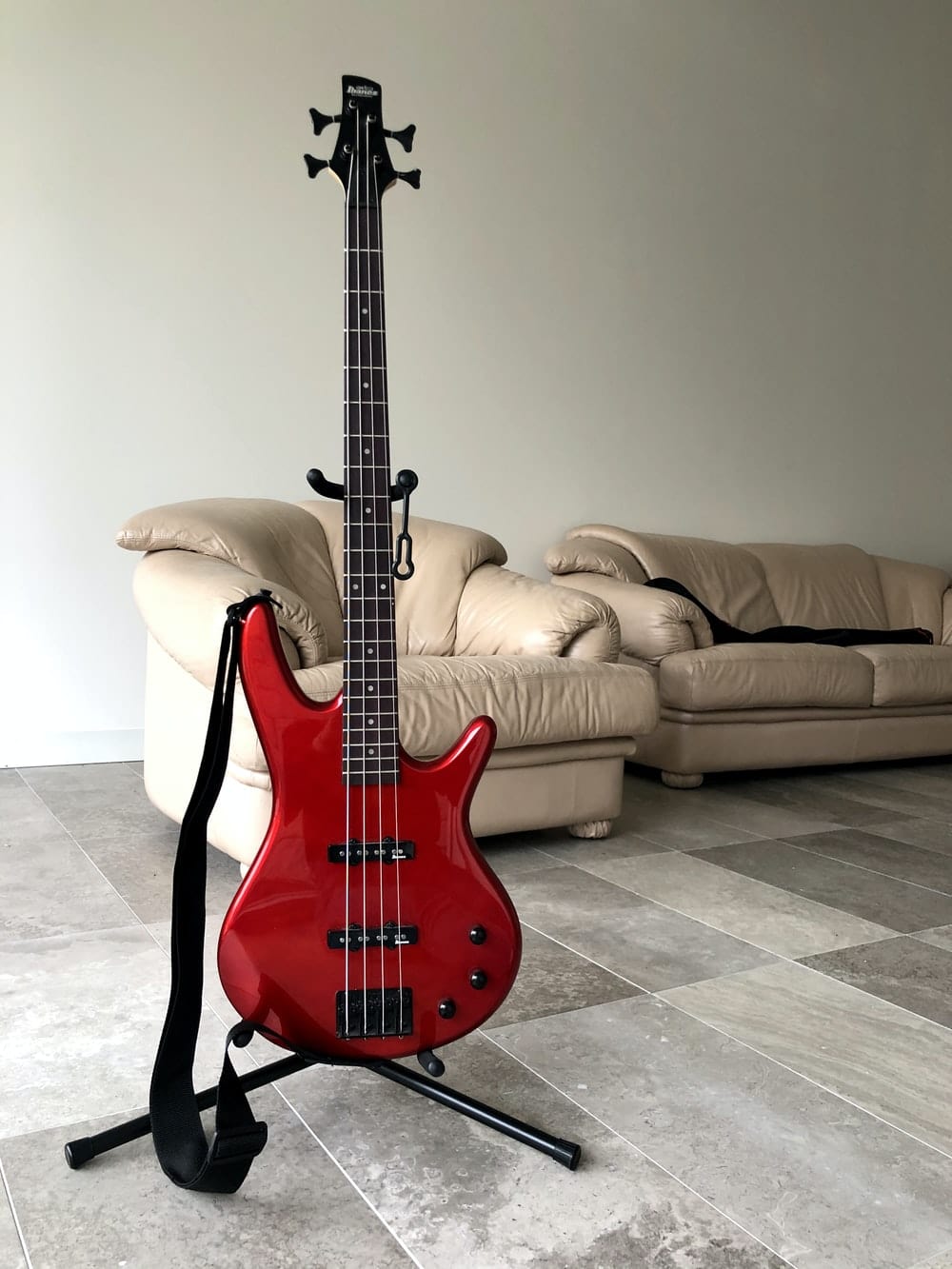 Cross Stitch | Bass - Red Electric Guitar On Black Steel Stand - Cross Stitched