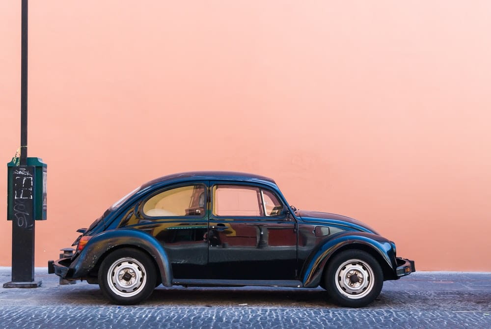 Cross Stitch | Beetle - Black Volkswagen Beetle Beside Beige Wall - Cross Stitched