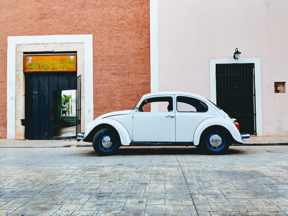 Cross Stitch | Beetle - White Volkswagen Beetle Parked Near Building During Daytime - Cross Stitched