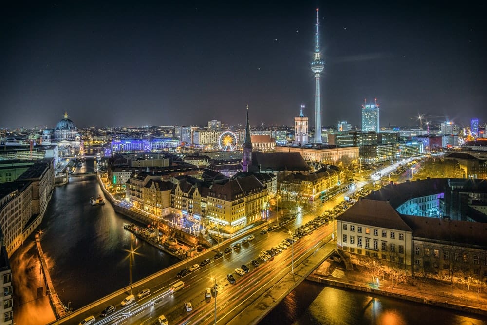 Cross Stitch | Berlin - Time-Lapse Photography Of Vehicle At The Road In Between The Building At Nighttime Aerial Photography - Cross Stitched