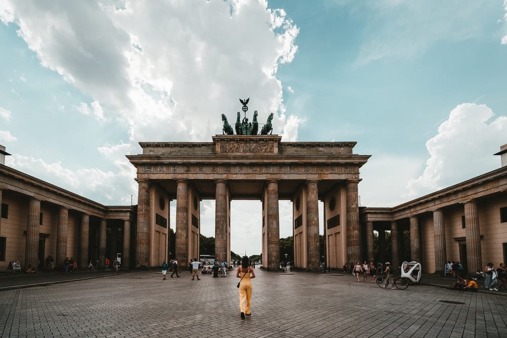 Cross Stitch | Berlin - Woman Standing Near Building - Cross Stitched