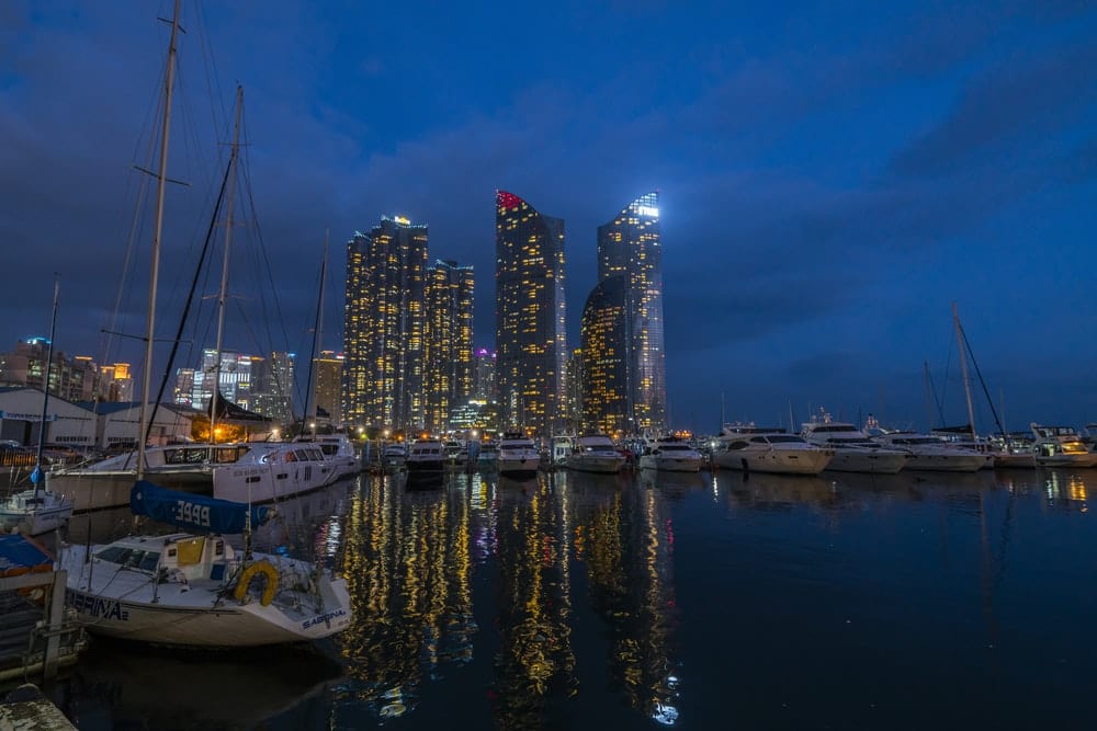 Cross Stitch | Busan - White Boat On Body Of Water Near City Buildings During Night Time - Cross Stitched