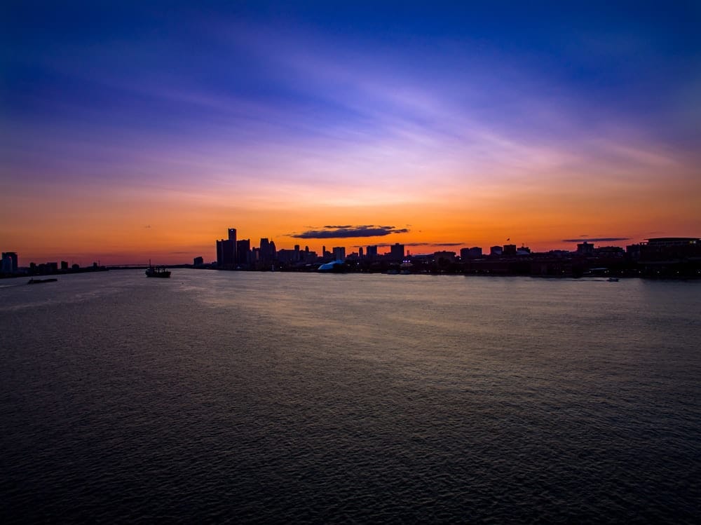 Cross Stitch | Detroit - Silhouette Of City Buildings And Boat Above Water At Golden Hour - Cross Stitched