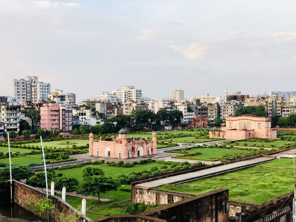 Cross Stitch | Dhaka - Beige Concrete Structure Near Grass Field - Cross Stitched