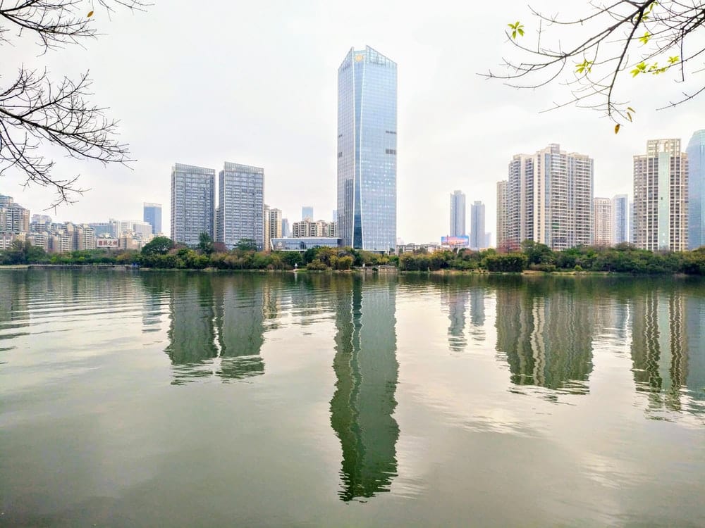 Cross Stitch | Huizhou - Body Of Water Near City Buildings During Daytime - Cross Stitched