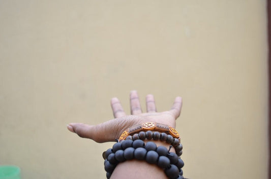 Cross Stitch | Lagos - Person Hand With Black Beaded Bracelets - Cross Stitched