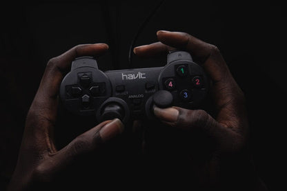 Cross Stitch | Lagos - Person Holding Black Havit Game Controller - Cross Stitched