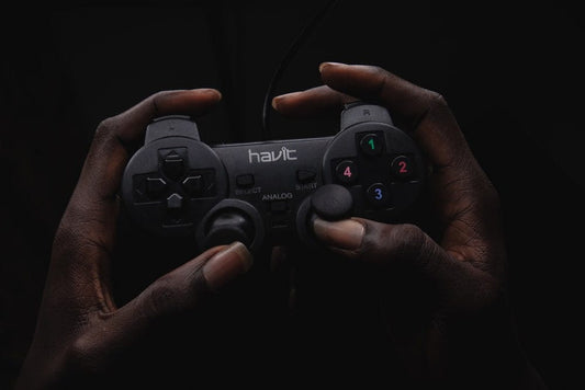 Cross Stitch | Lagos - Person Holding Black Havit Game Controller - Cross Stitched