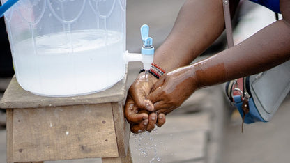 Cross Stitch | Lagos - Person Holding White Plastic Bottle - Cross Stitched