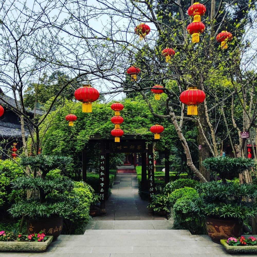 Cross Stitch | Leshan - Hanging Red Chinese Lanterns Near Trees And Tunnel During Day - Cross Stitched