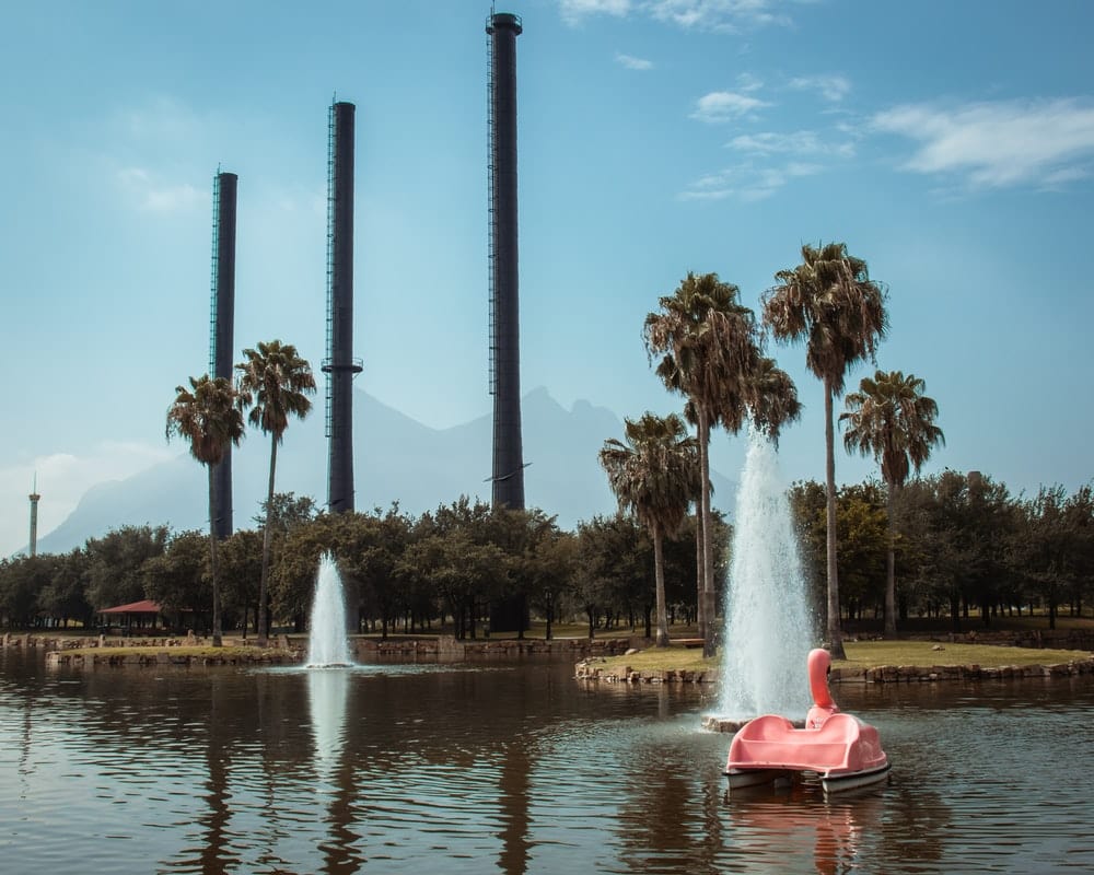 Cross Stitch | Monterrey - Person In Red Kayak On Water Fountain During Daytime - Cross Stitched