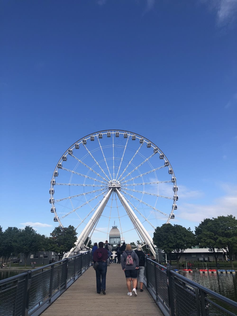 Cross Stitch | Montréal - People Walking On Street Near Ferris Wheel Under Blue Sky During Daytime - Cross Stitched