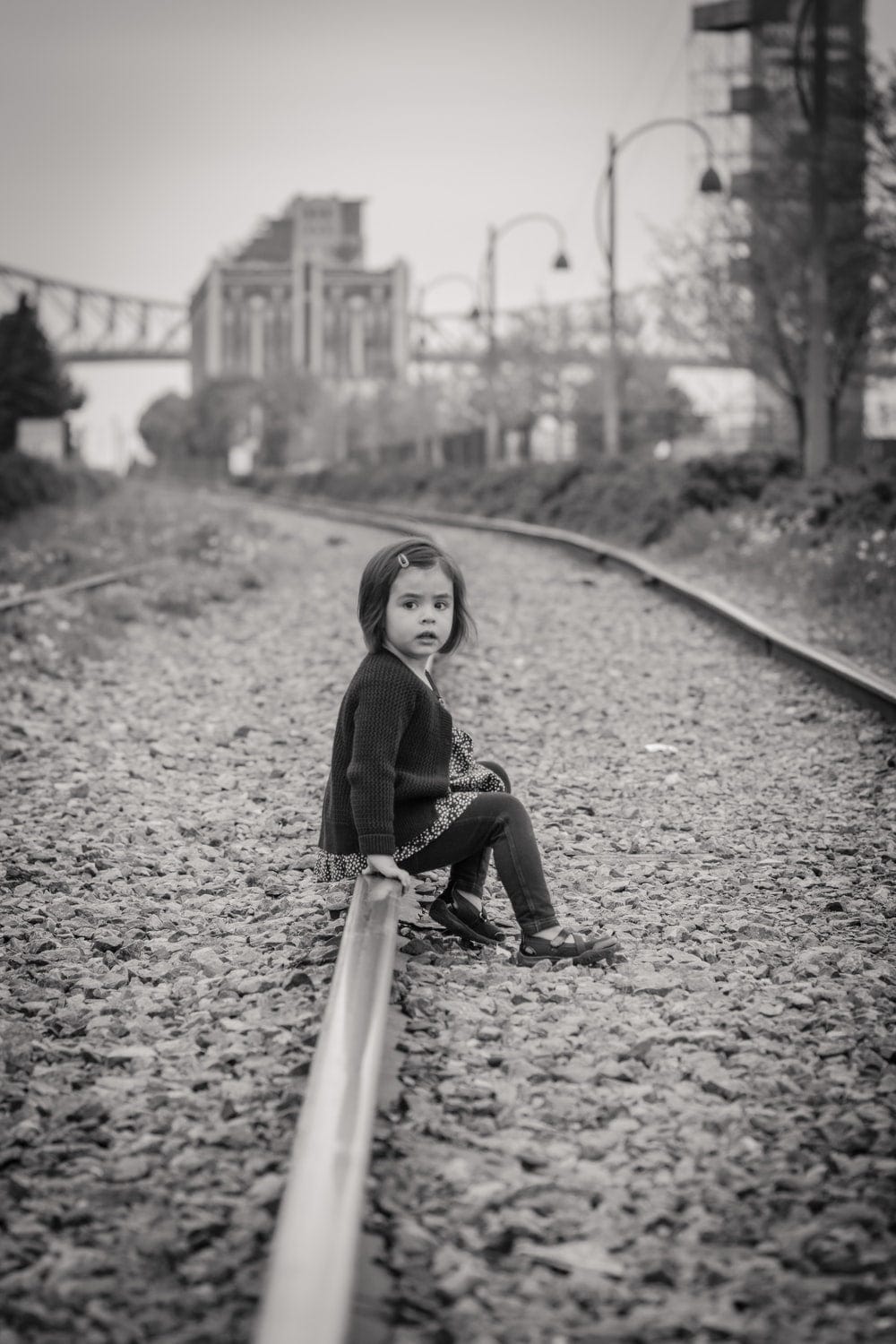 Cross Stitch | Montréal - Woman In Black Jacket Sitting On Train Rail During Daytime - Cross Stitched