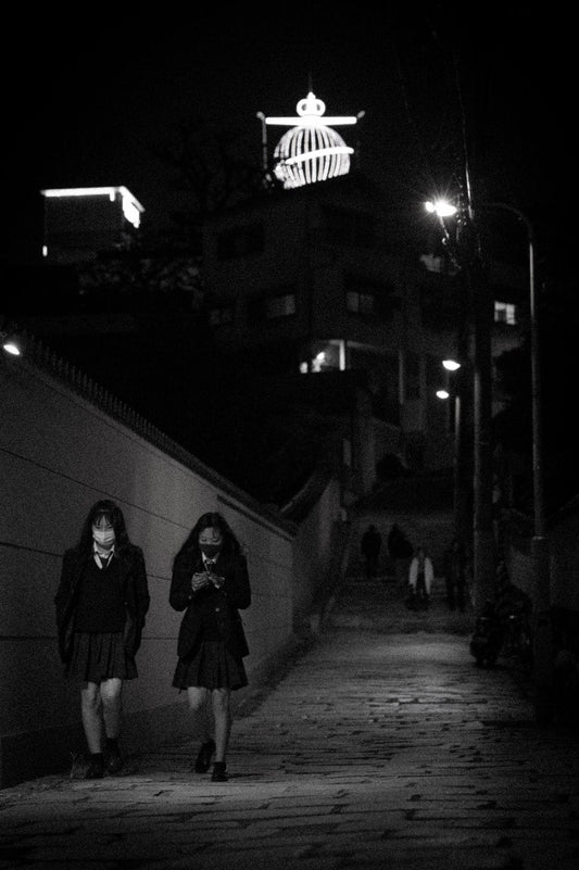 Cross Stitch | Ōsaka - Woman In Black Coat Standing Near Wall During Night Time - Cross Stitched
