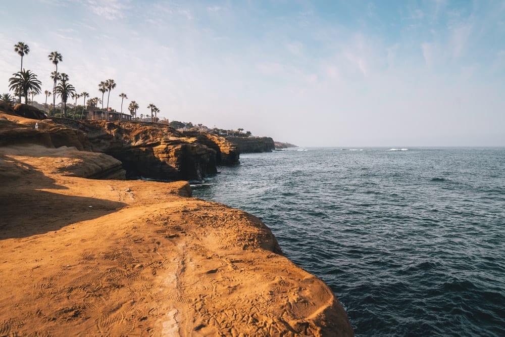 Cross Stitch | San Diego - People On Brown Rock Formation Near Body Of Water During Daytime - Cross Stitched