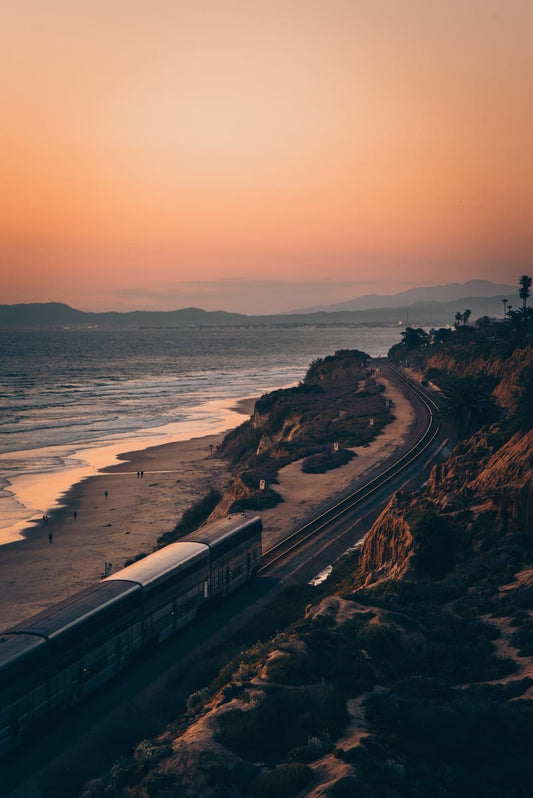 Cross Stitch | San Diego - White And Black Train On Rail Near Body Of Water During Sunset - Cross Stitched