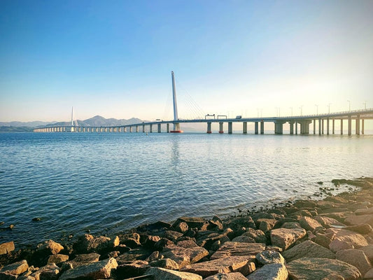 Cross Stitch | Shenzhen - Rocks On Beach Near Bridge Under Blue Sky During Daytime - Cross Stitched