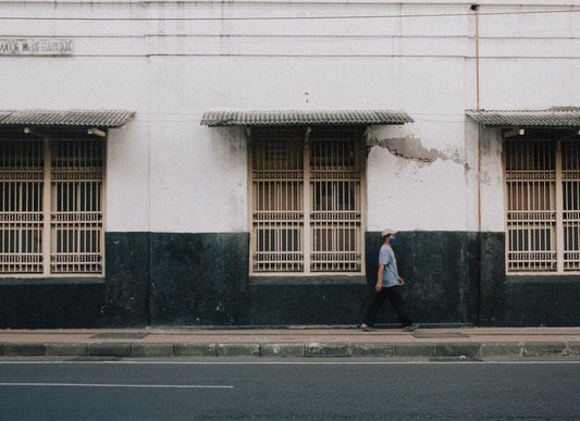 Cross Stitch | Surabaya - Man In Black Jacket Standing In Front Of White Concrete Building During Daytime - Cross Stitched