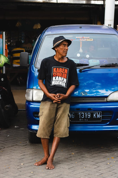 Cross Stitch | Surabaya - Man Leaning On Blue Vehicle During Daytime - Cross Stitched