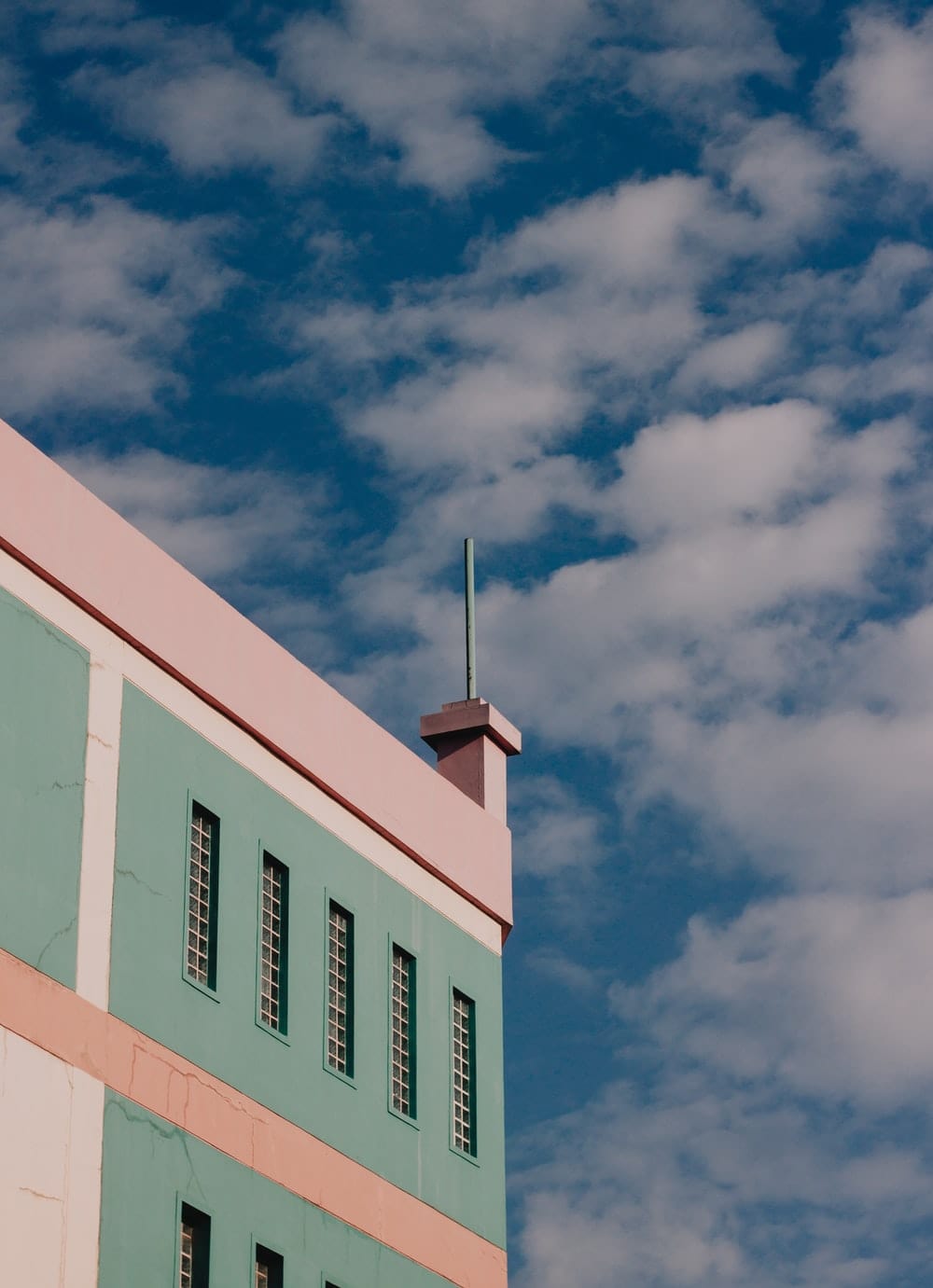 Cross Stitch | Surabaya - White And Pink Concrete Building Under Blue Sky During Daytime - Cross Stitched