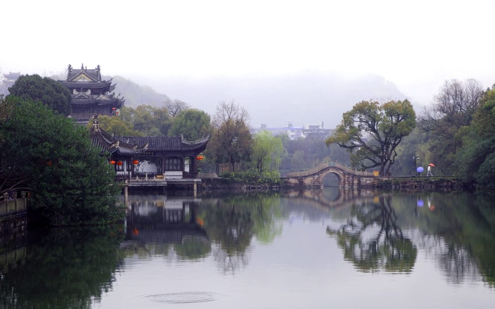 Cross Stitch | Taizhou - Brown And Black House Near Green Trees And Lake During Daytime - Cross Stitched