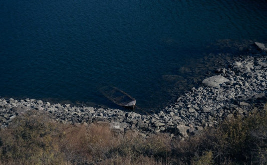 Cross Stitch | Ürümqi - Brown Boat Beside Body Of Water - Cross Stitched