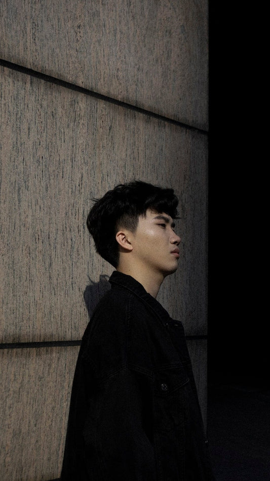 Cross Stitch | Yangzhou - Man In Black Jacket Standing Beside Brown Wall - Cross Stitched