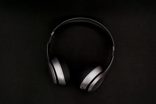 Cross Stitch | Zhangjiakou - Silver Headphones On Top Of Black Surface - Cross Stitched
