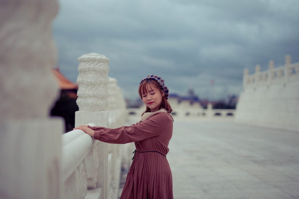 Cross Stitch | Zhongshan - Woman In Brown Long Sleeve Dress Standing On White Sand During Daytime - Cross Stitched